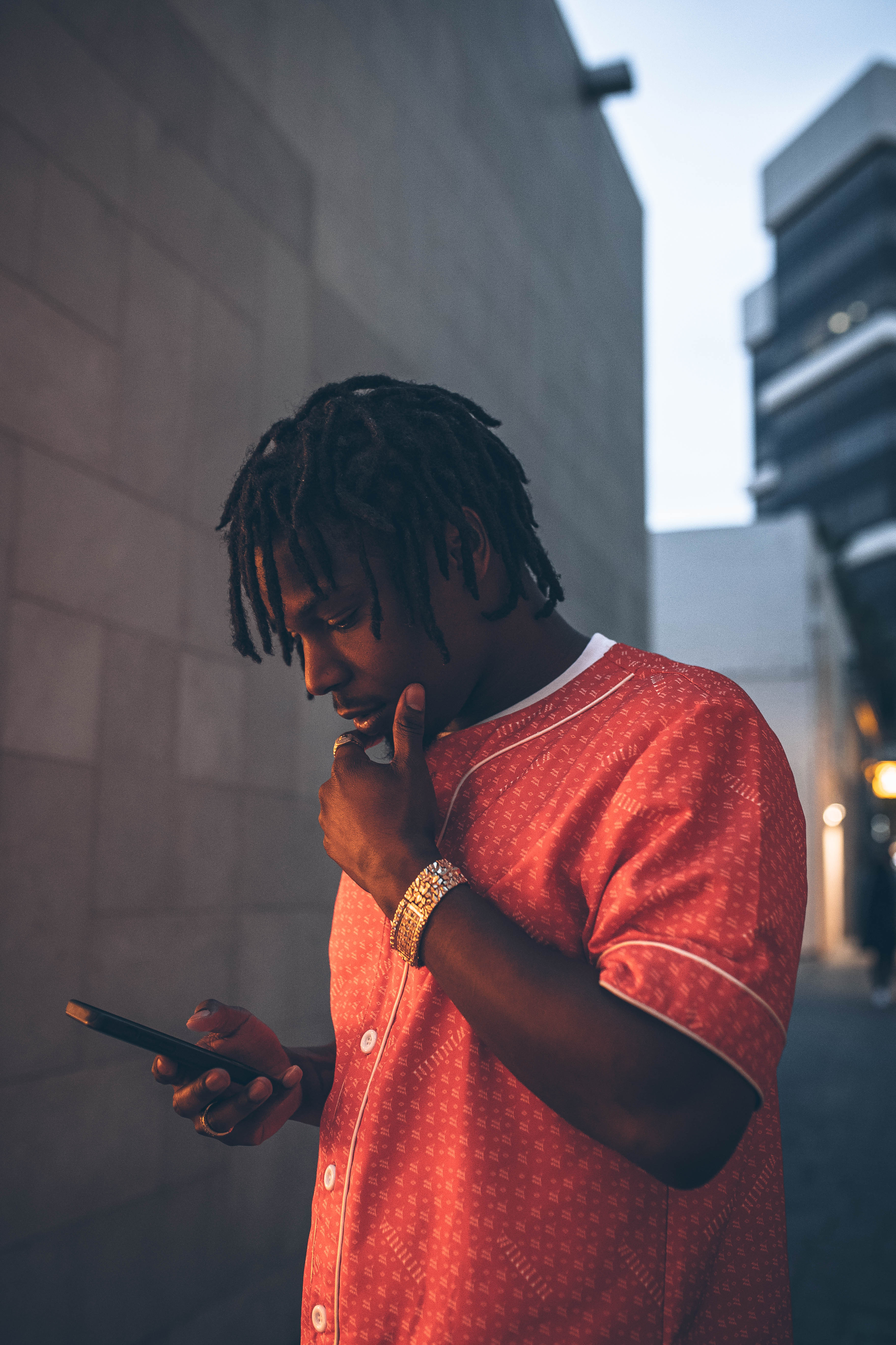 Model wearing a red WINNIN shirt in an urban setting
